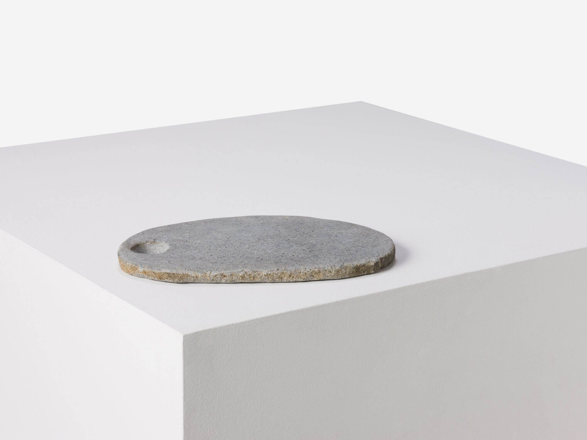 Left side view of small natural stone platter